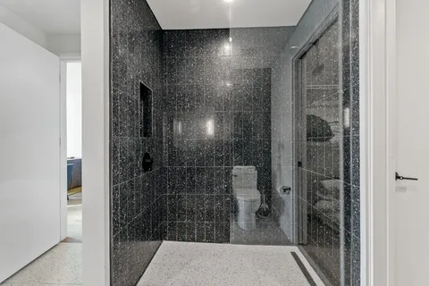 a bathroom with a glass door shower