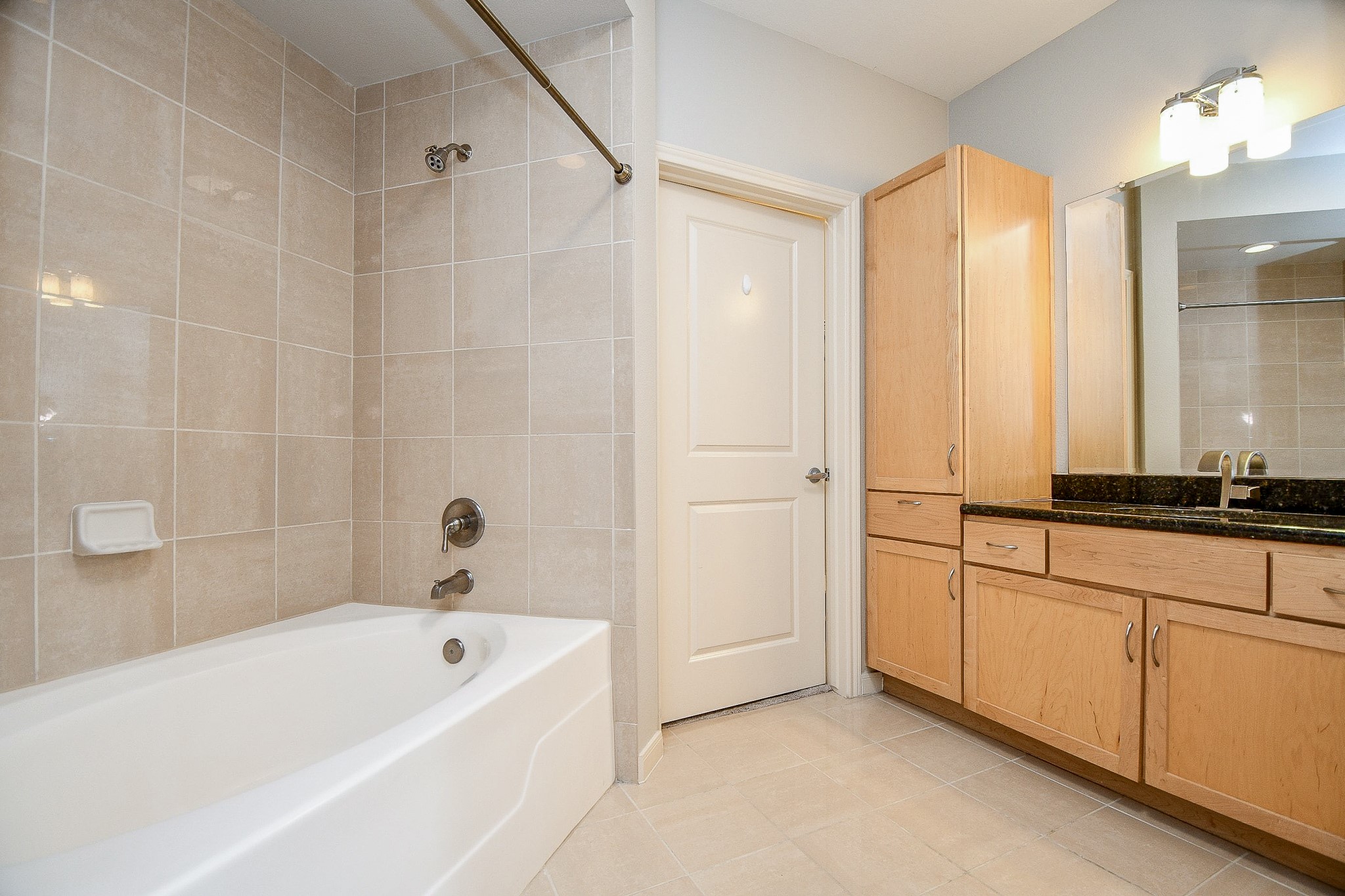 505 Jackson Hill Street, Unit 307 Houston, TX 77007 - Photo 14 of 30 a bathroom with a tub sink and mirror