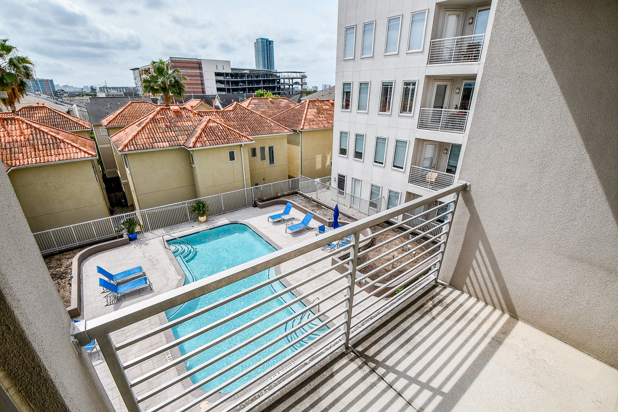 505 Jackson Hill Street, Unit 307 Houston, TX 77007 - Photo 16 of 30 a view of balcony with two chairs and a rug