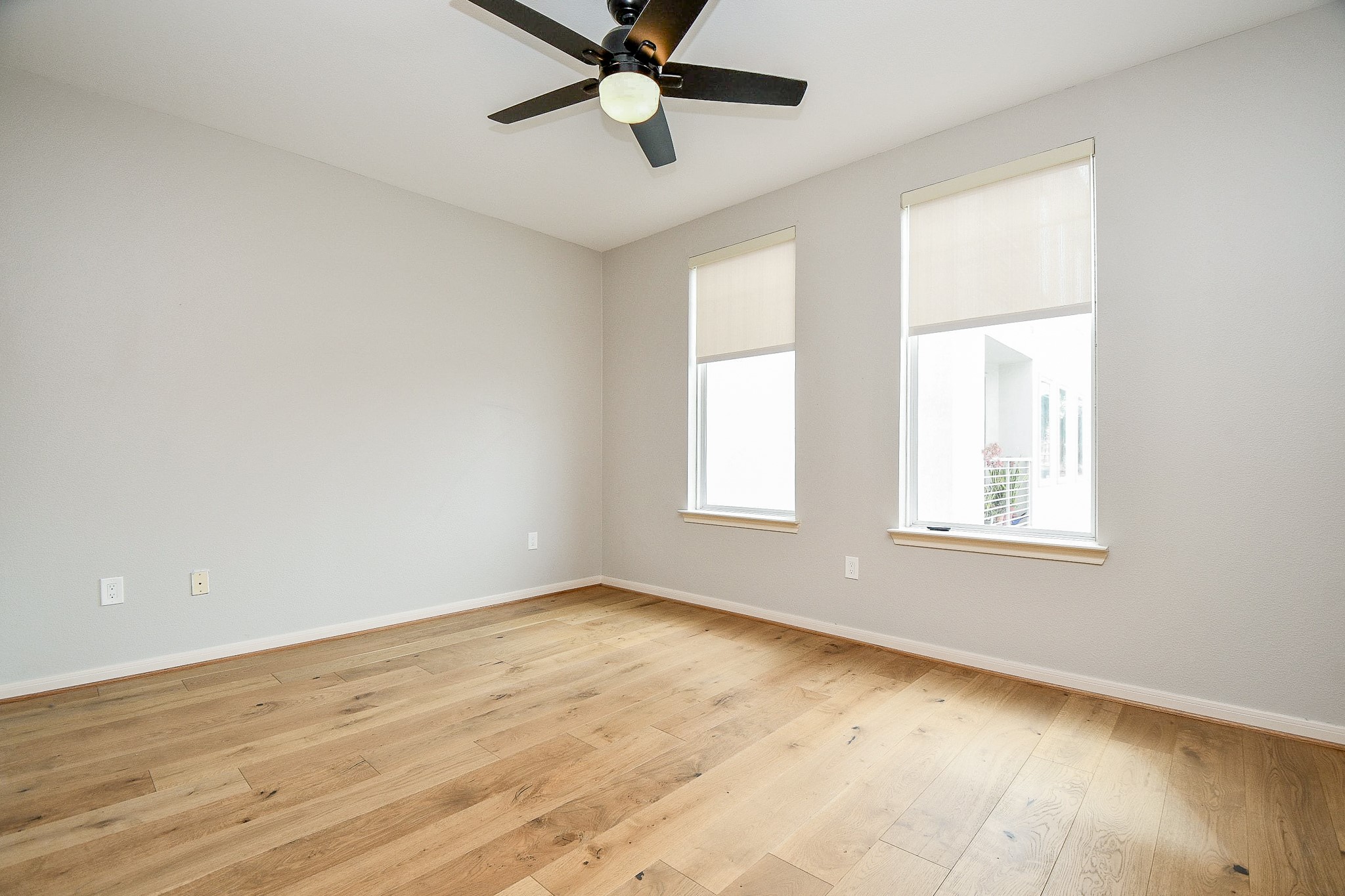 505 Jackson Hill Street, Unit 307 Houston, TX 77007 - Photo 20 of 30 a view of an empty room with a window and wooden floor