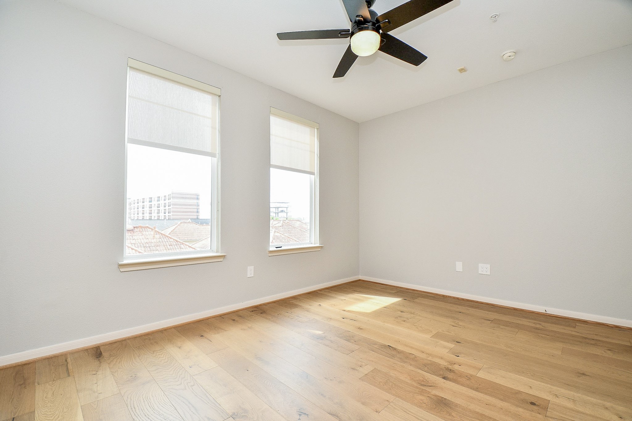 505 Jackson Hill Street, Unit 307 Houston, TX 77007 - Photo 21 of 30 a view of an empty room with wooden floor and a window
