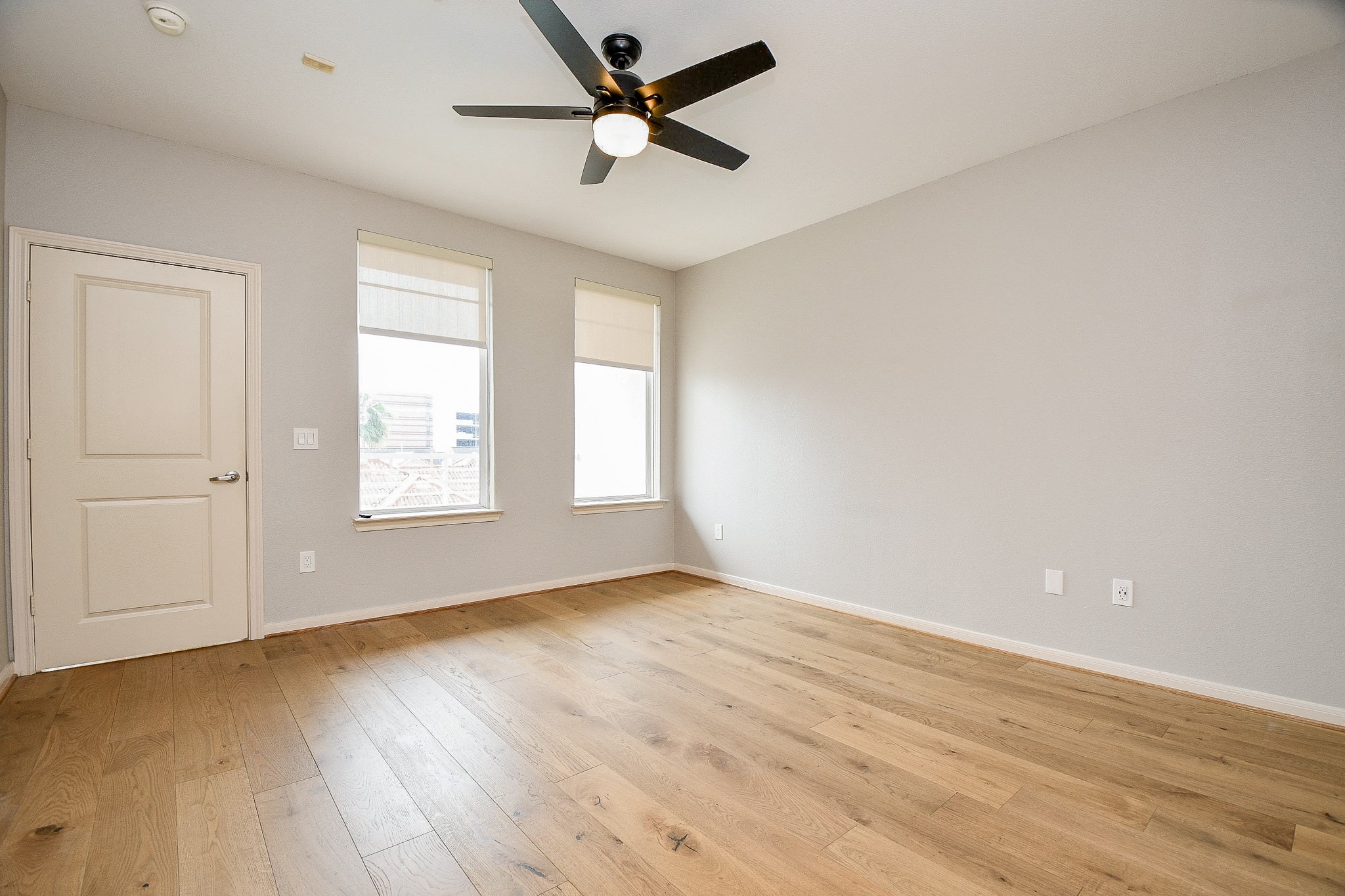 505 Jackson Hill Street, Unit 307 Houston, TX 77007 - Photo 22 of 30 an empty room with wooden floor fan and windows