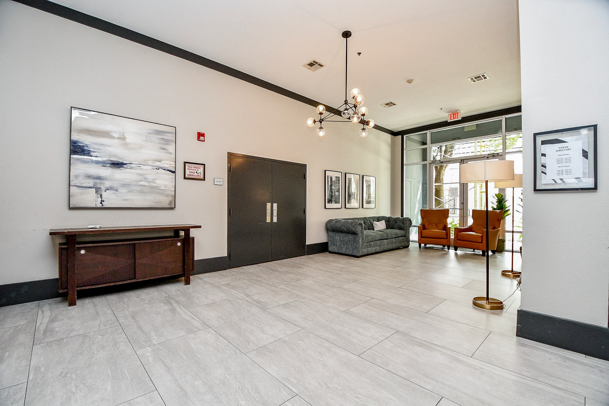 505 Jackson Hill Street, Unit 307 Houston, TX 77007 - Photo 27 of 30 a large living room with furniture and a chandelier