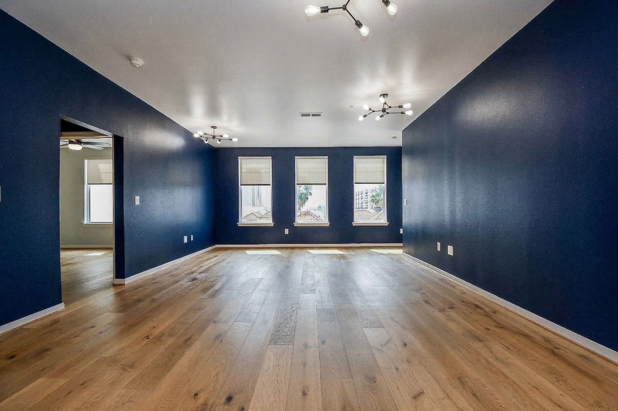 505 Jackson Hill Street, Unit 307 Houston, TX 77007 - Photo 3 of 30 an empty room with wooden floor and windows