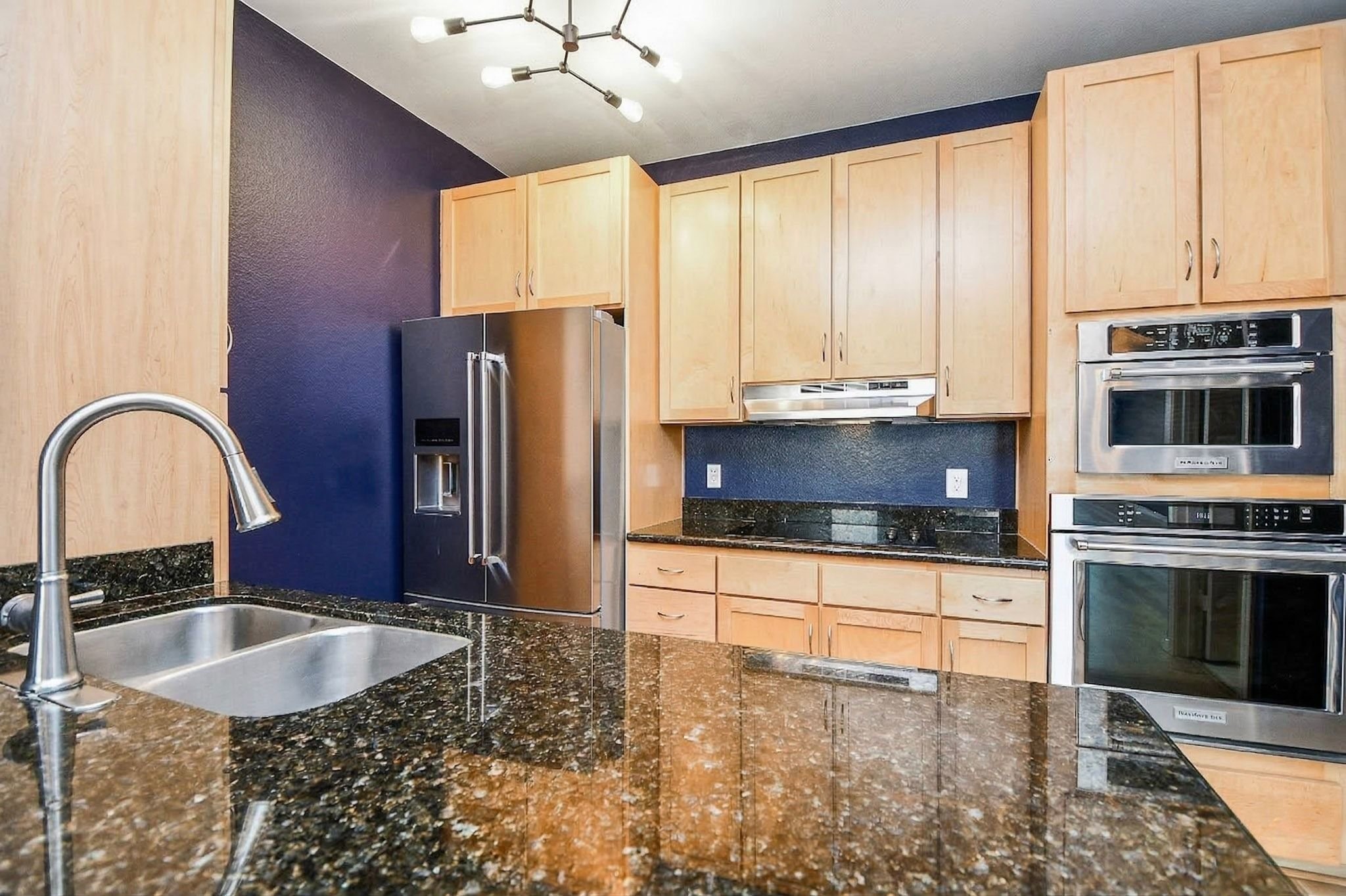 505 Jackson Hill Street, Unit 307 Houston, TX 77007 - Photo 7 of 30 a kitchen with stainless steel appliances a stove sink and cabinets