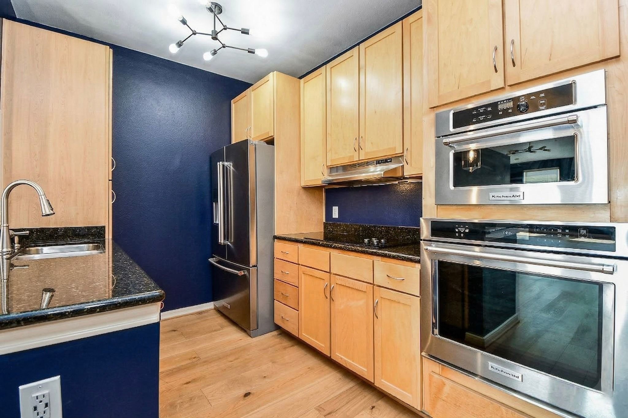 505 Jackson Hill Street, Unit 307 Houston, TX 77007 - Photo 9 of 30 a kitchen with granite countertop stainless steel appliances and wooden cabinets