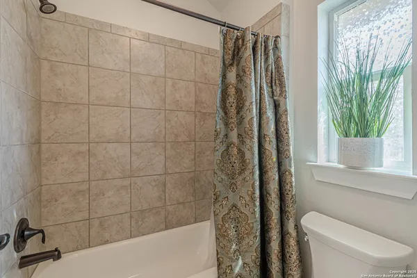 a bathroom with a shower and a toilet