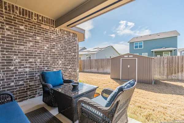 a view of a patio with a table and chairs