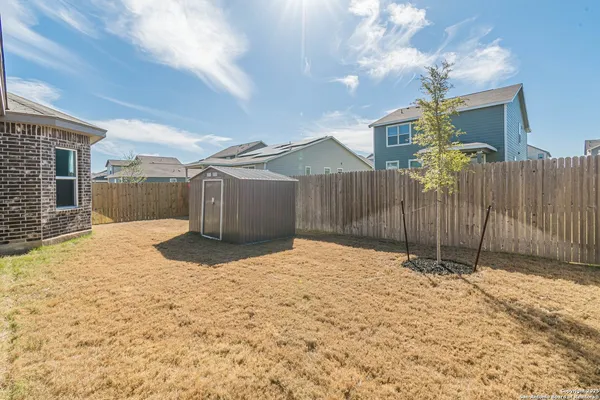 a view of a backyard of the house
