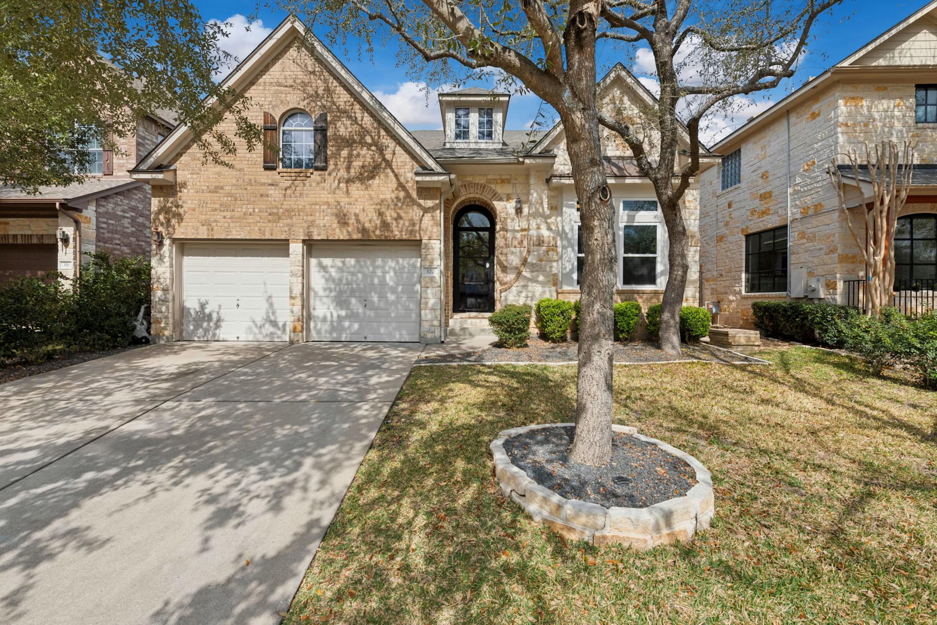 320 El Socorro Lane Austin, TX 78732 - Photo 13 of 40 a front view of a house with a yard