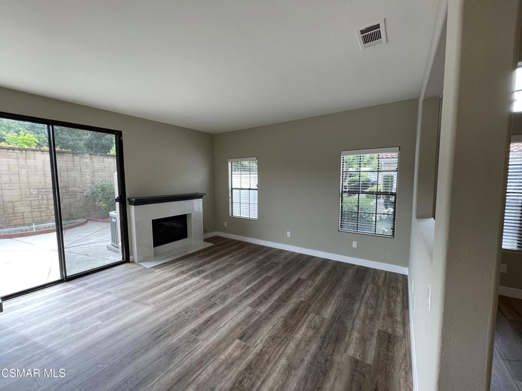 429 Dante Way Oak Park, CA 91377 - Photo 14 of 37 wooden floor fireplace and windows in an empty room