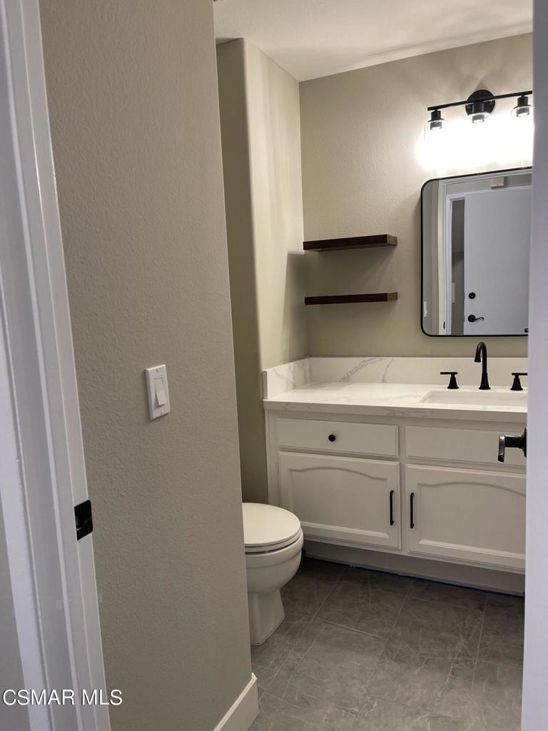 429 Dante Way Oak Park, CA 91377 - Photo 16 of 37 a bathroom with a toilet a sink a mirror and a faucet