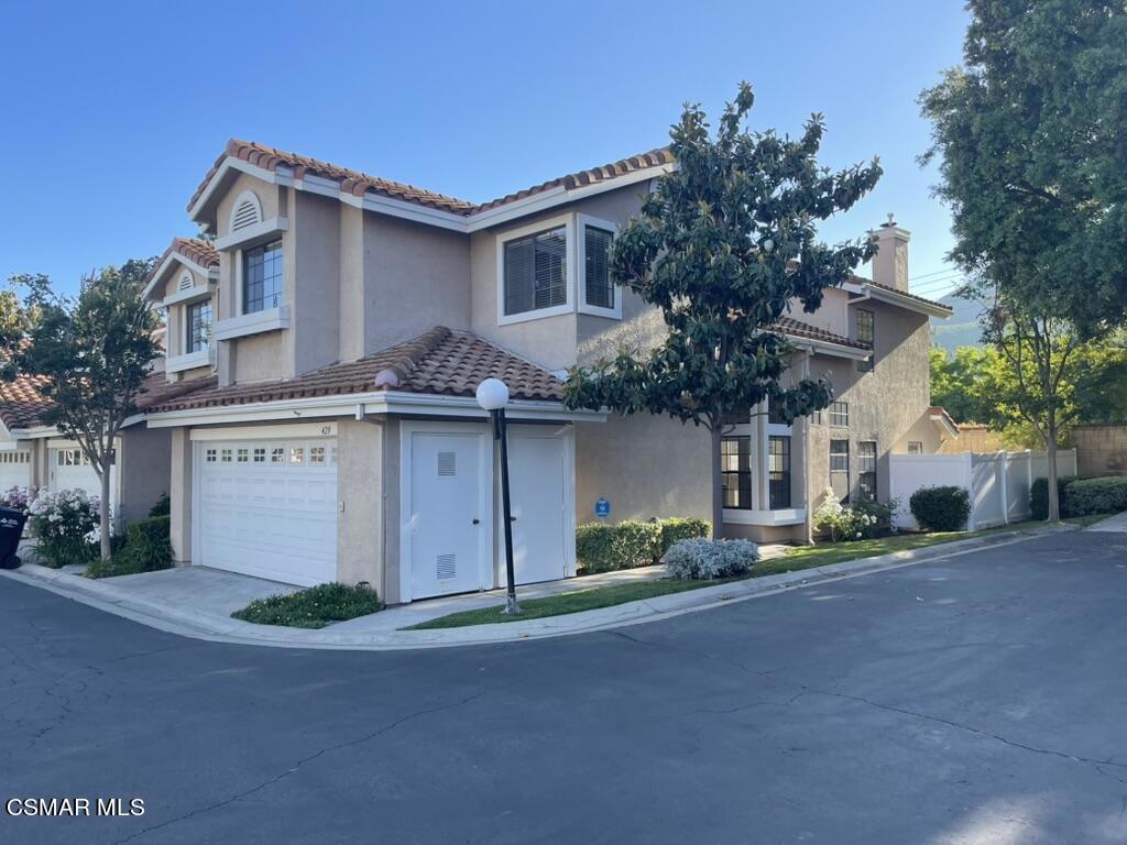 429 Dante Way Oak Park, CA 91377 - Photo 2 of 37 a front view of a house with a yard and garage