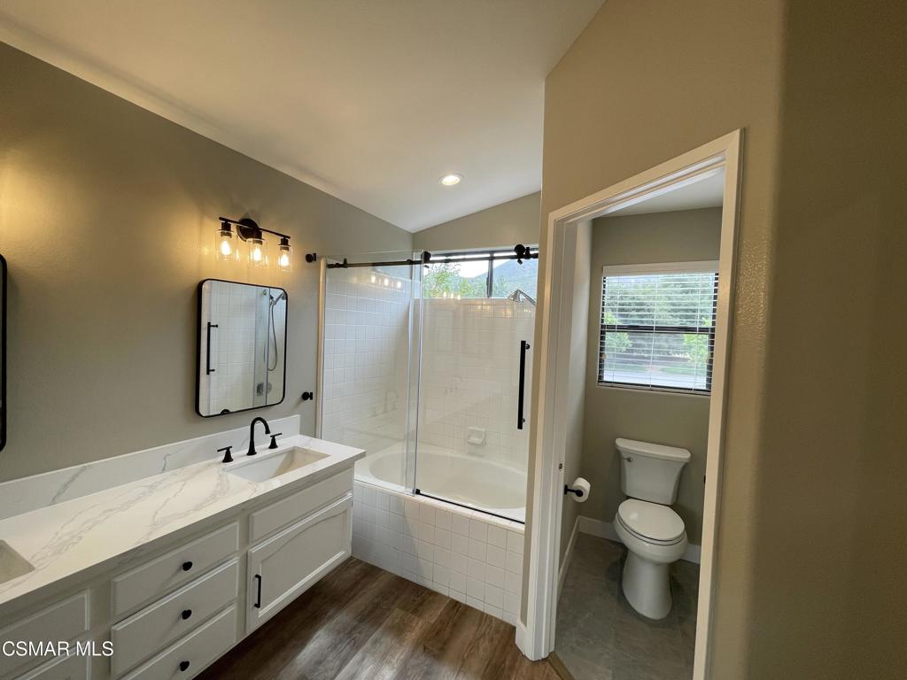 429 Dante Way Oak Park, CA 91377 - Photo 26 of 37 a bathroom with a double vanity sink toilet mirror and bathtub