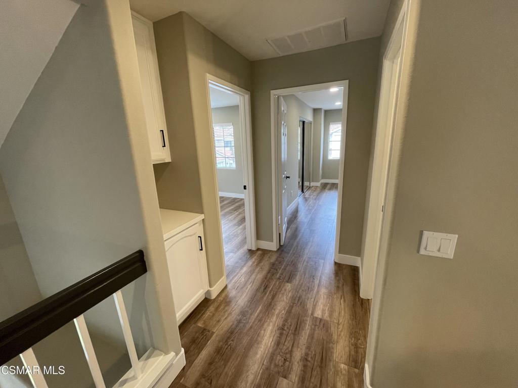 429 Dante Way Oak Park, CA 91377 - Photo 29 of 37 a view of a hallway with wooden floor and staircase