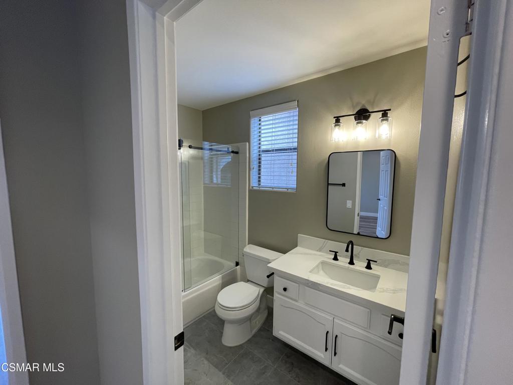 429 Dante Way Oak Park, CA 91377 - Photo 30 of 37 a bathroom with a toilet sink and mirror