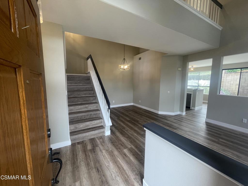 429 Dante Way Oak Park, CA 91377 - Photo 4 of 37 a view of a hallway with wooden floor and staircase