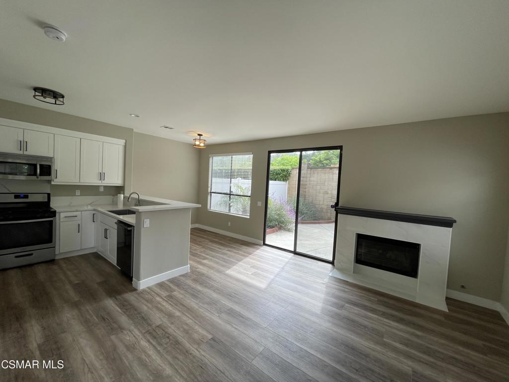 429 Dante Way Oak Park, CA 91377 - Photo 10 of 37 a kitchen with stainless steel appliances kitchen island wooden cabinets and entryway