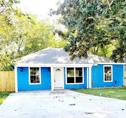 a front view of a house with a garden and yard