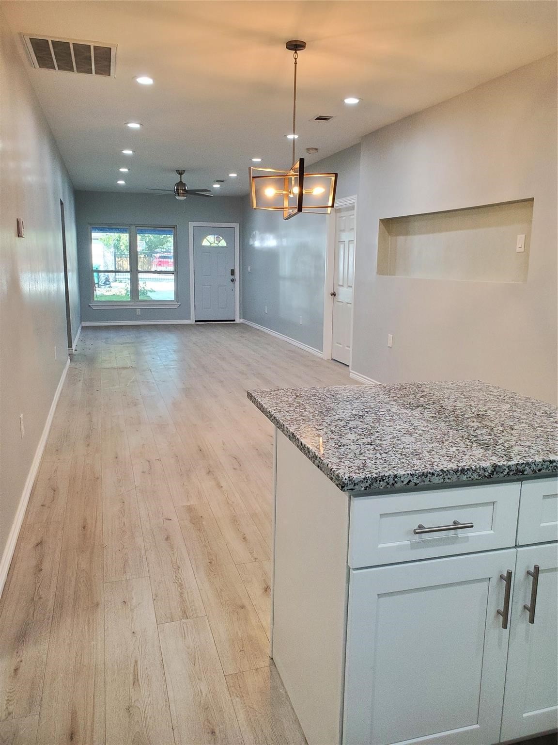 6815 Sidney Street Houston, TX 77021 - Photo 7 of 14 a kitchen with kitchen island granite countertop wooden cabinets and a granite counter tops