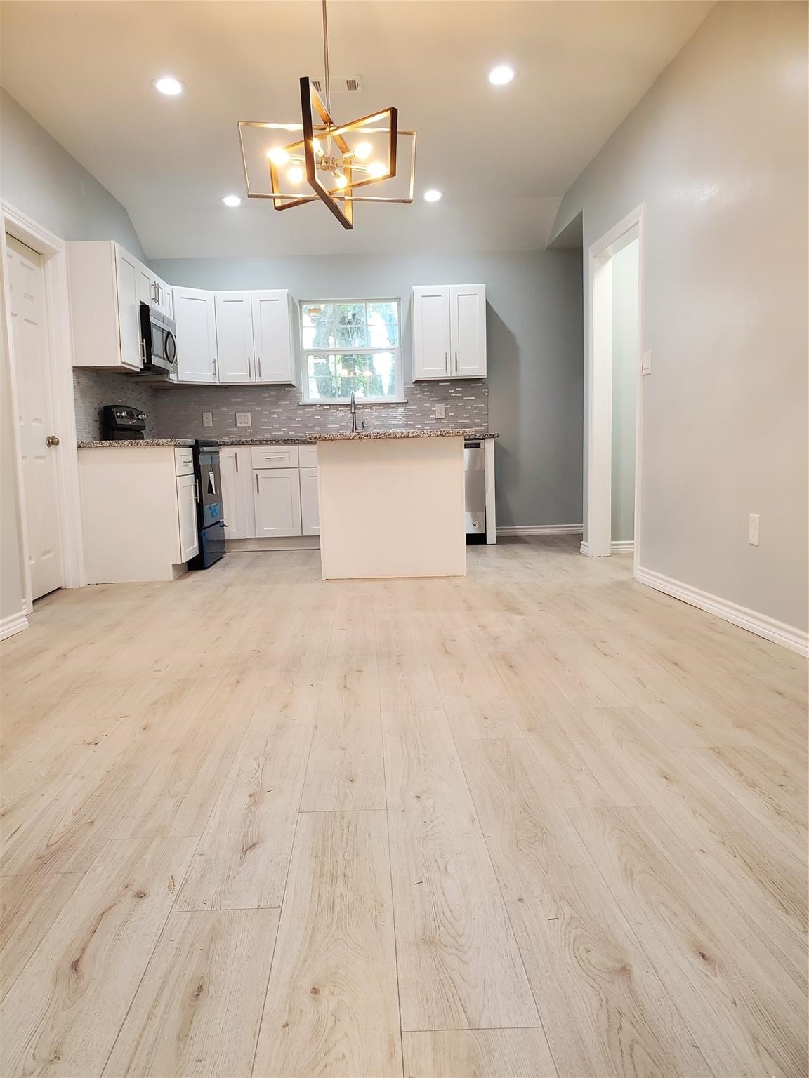 6815 Sidney Street Houston, TX 77021 - Photo 9 of 14 a view of a kitchen with a sink cabinets and wooden floor