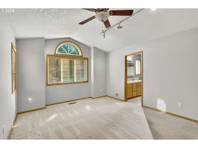a view of an empty room and a window
