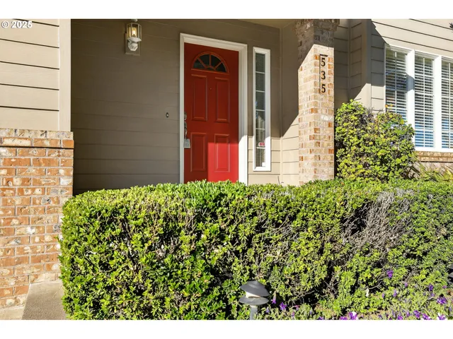 a view of a house with a flower garden