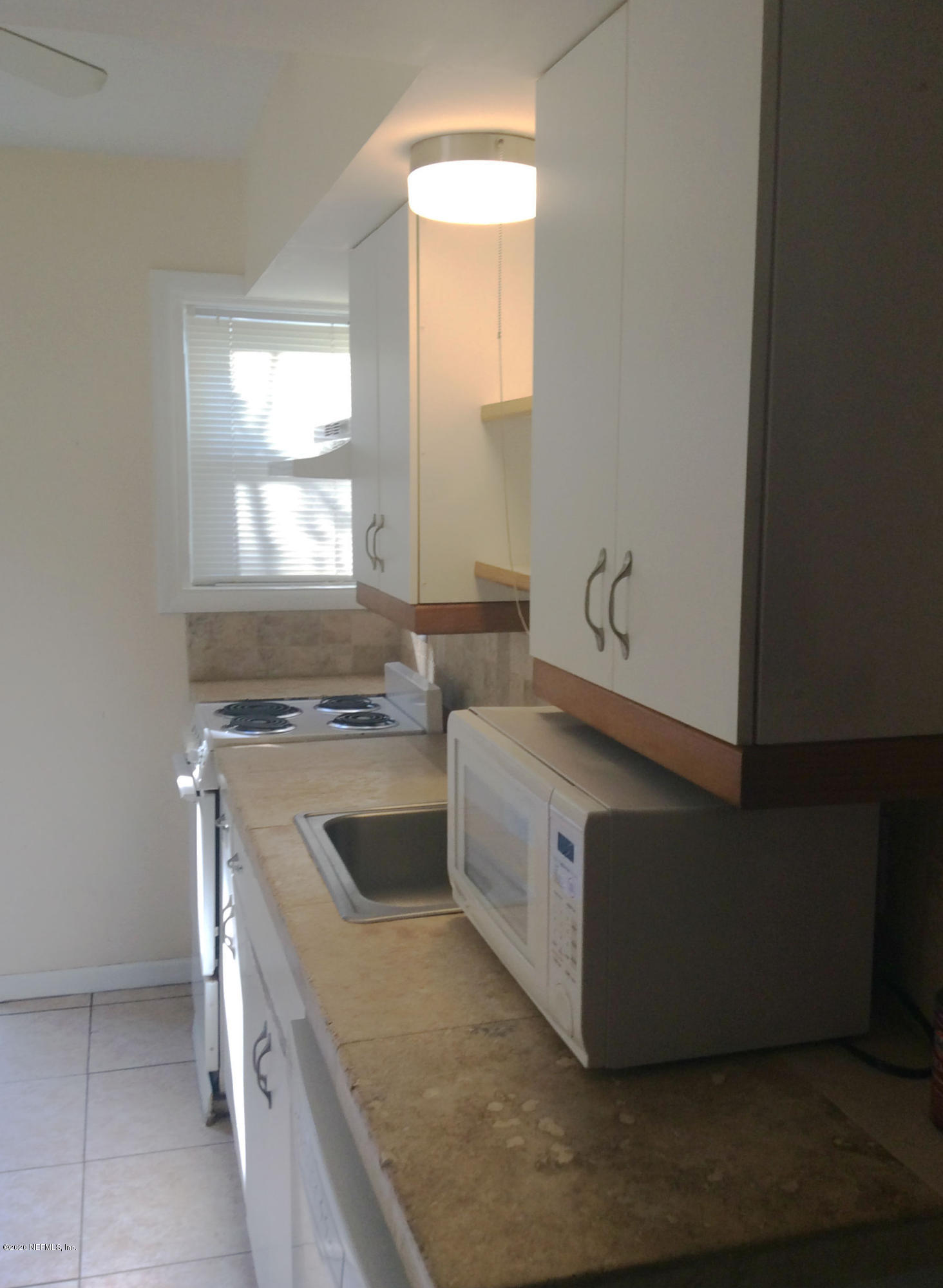 9 Sylvan Drive, Unit B St. Augustine, FL 32084 - Photo 3 of 10 a kitchen with stainless steel appliances granite countertop a sink and a stove