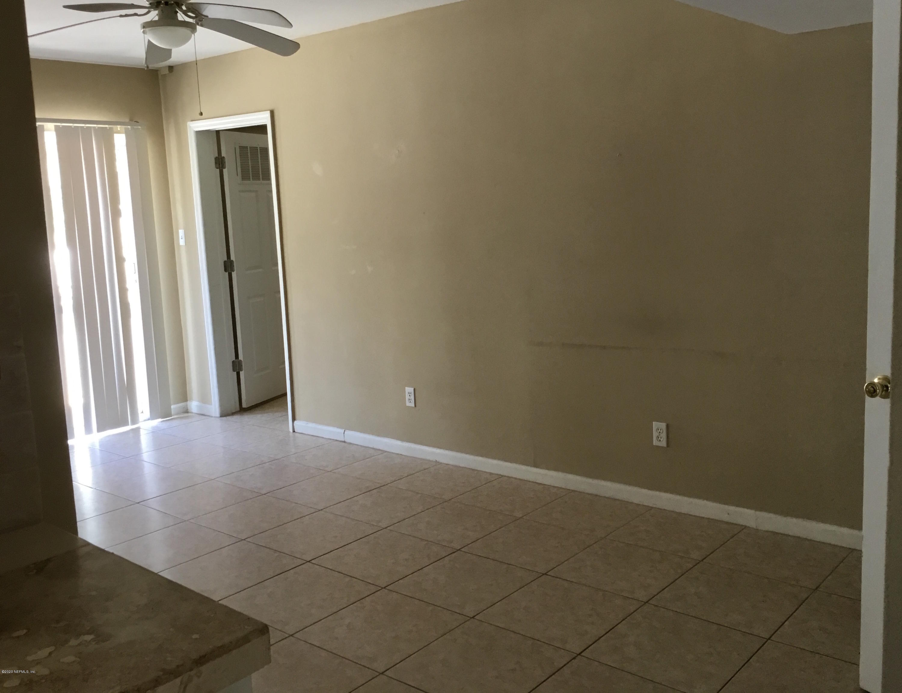 9 Sylvan Drive, Unit B St. Augustine, FL 32084 - Photo 6 of 10 an empty room with windows and entrance