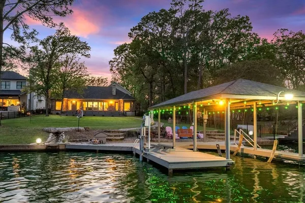 a view of a swimming pool and lounge chairs in patio