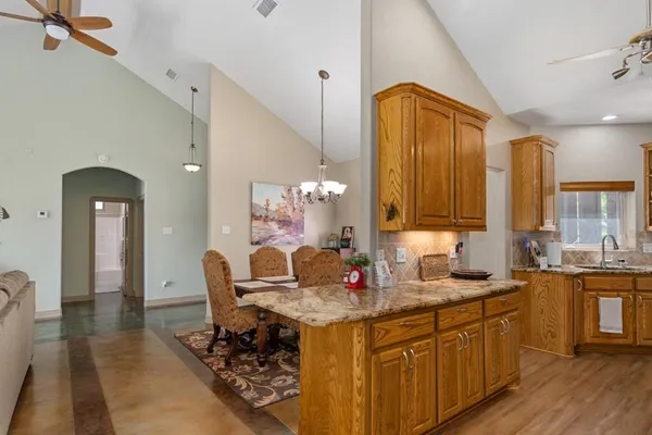 a kitchen with a sink cabinets and dining table