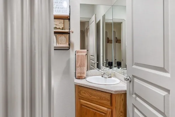 a bathroom with a sink a vanity and a mirror