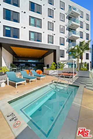a view of a building with swimming pool and sitting area