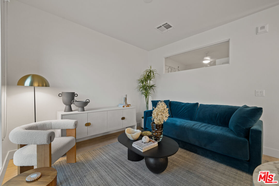 250 East Broadway, Unit 803 Long Beach, CA 90802 - Photo 34 of 44 a living room with furniture and wooden floor