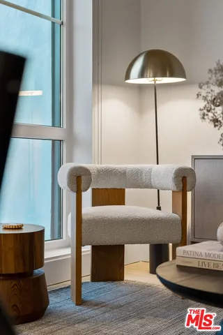 a bedroom with a bed a mirror and dresser