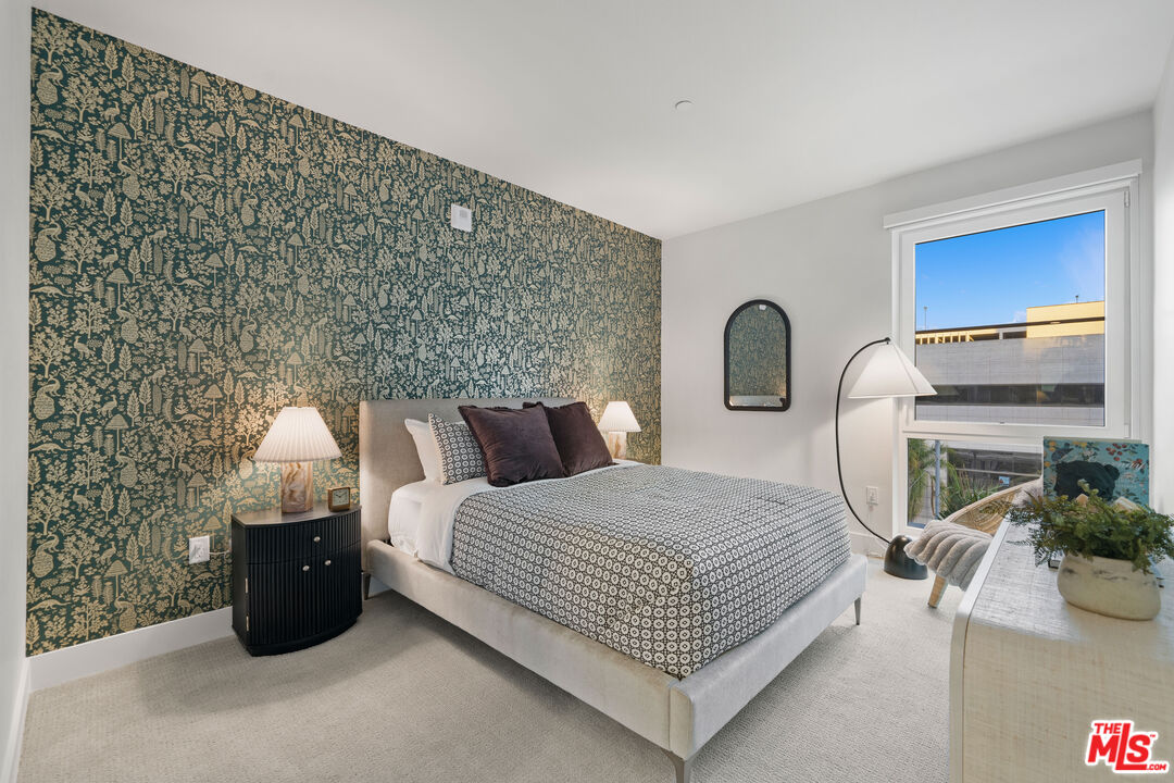 250 East Broadway, Unit 803 Long Beach, CA 90802 - Photo 37 of 44 a bedroom with a bed a mirror and dresser