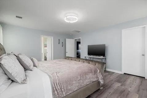 a bedroom with a bed and a flat screen tv