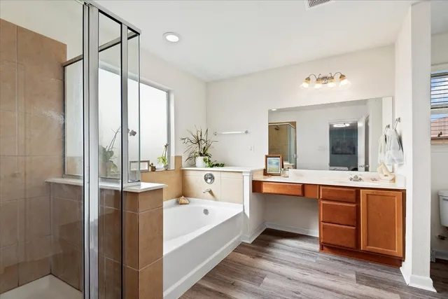a large spacious bathroom with a large tub and shower