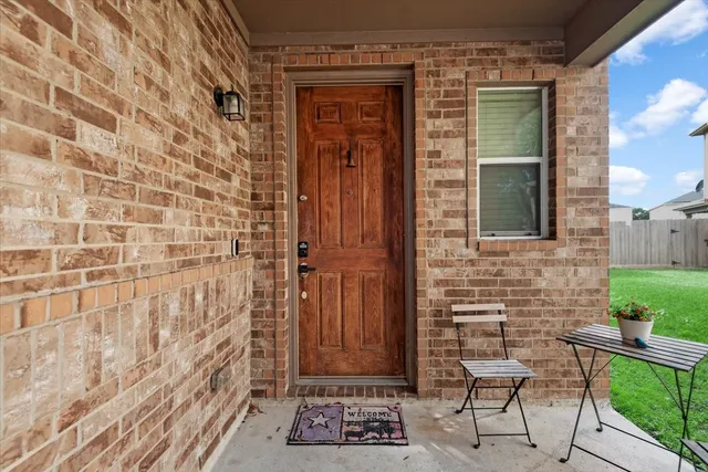 a view of a wooden door with a bench and chair