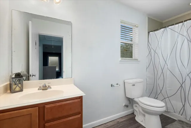 a bathroom with a sink a toilet and a mirror