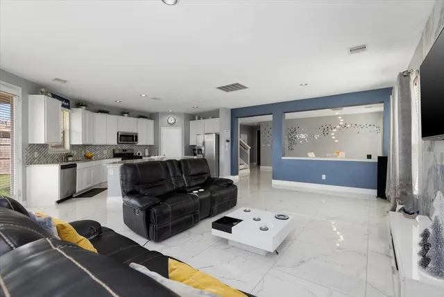a living room with furniture and a flat screen tv