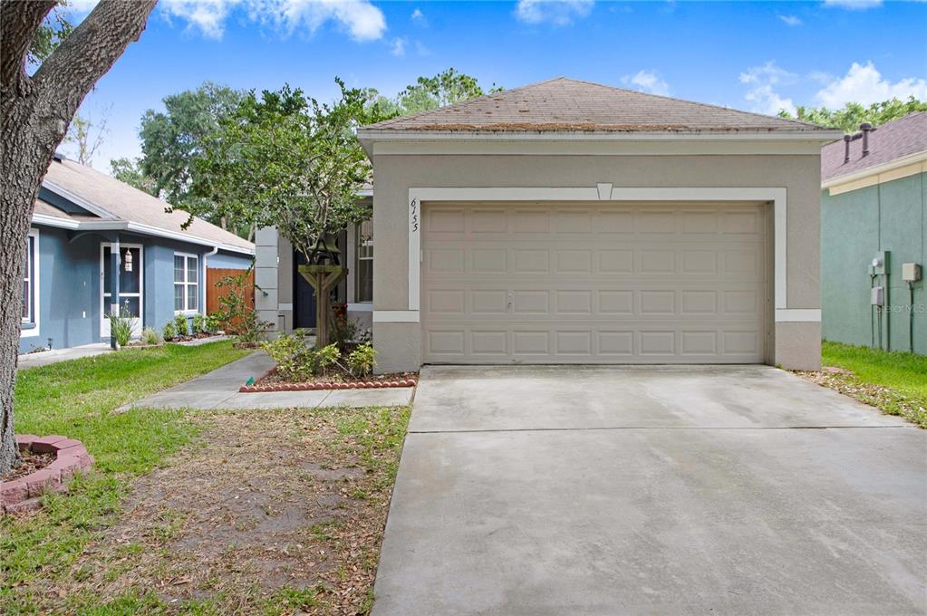 a front view of a house with a yard and garage