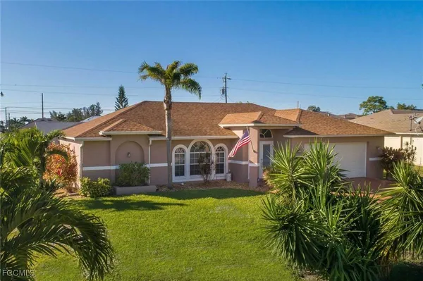 a front view of house with yard and green space