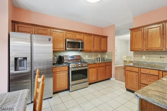 a kitchen with stainless steel appliances granite countertop a sink and cabinets