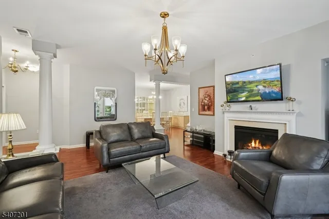 a living room with furniture a couch and paintings on the wall