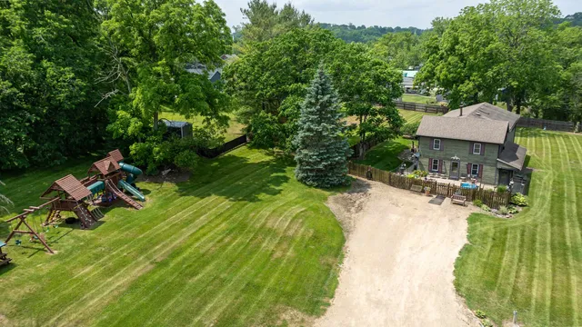 a front view of house with yard and trees