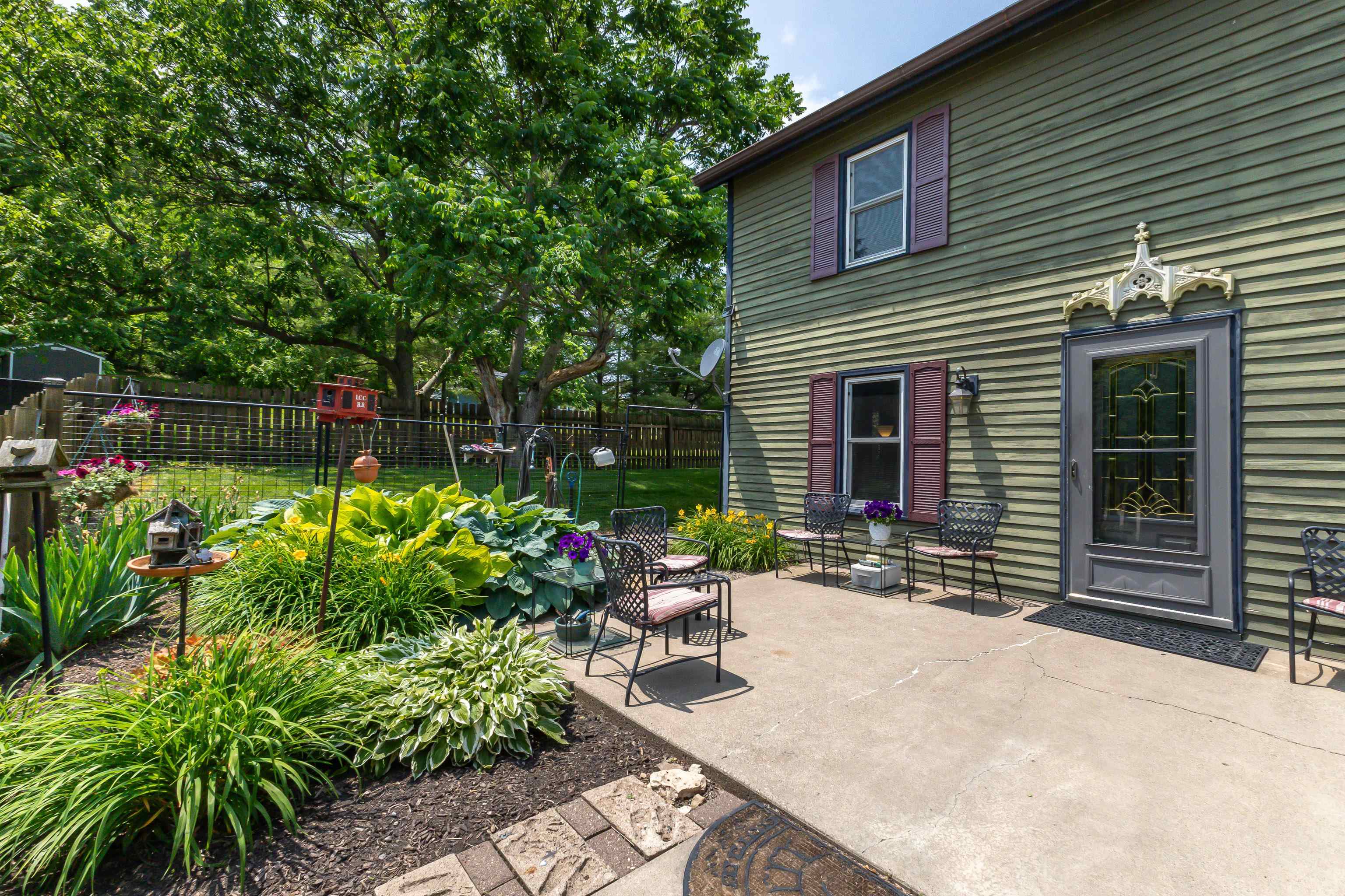 103 4th Street Galena, IL 61036 - Photo 11 of 64 a backyard of a house with a garden and outdoor seating