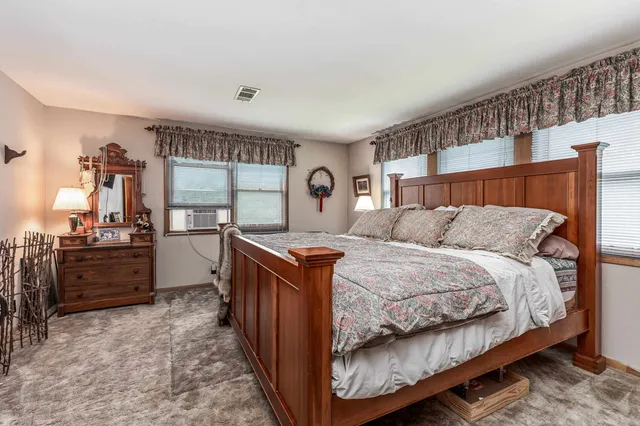 a living room with furniture a fireplace and a floor to ceiling window