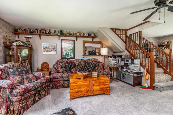 a kitchen with stainless steel appliances granite countertop a stove top oven a sink dishwasher and cabinets with wooden floor