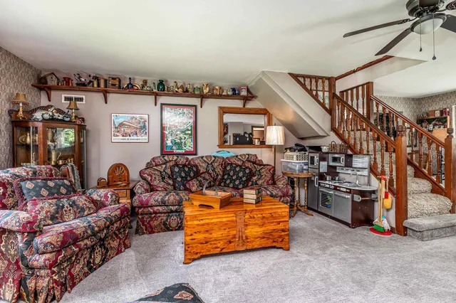 a kitchen with stainless steel appliances granite countertop a stove top oven a sink dishwasher and cabinets with wooden floor